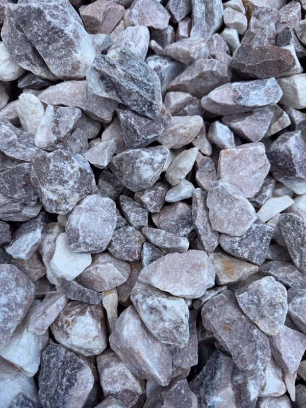 Loose gray and lavender-toned rocks and pebbles with a dusty white coating